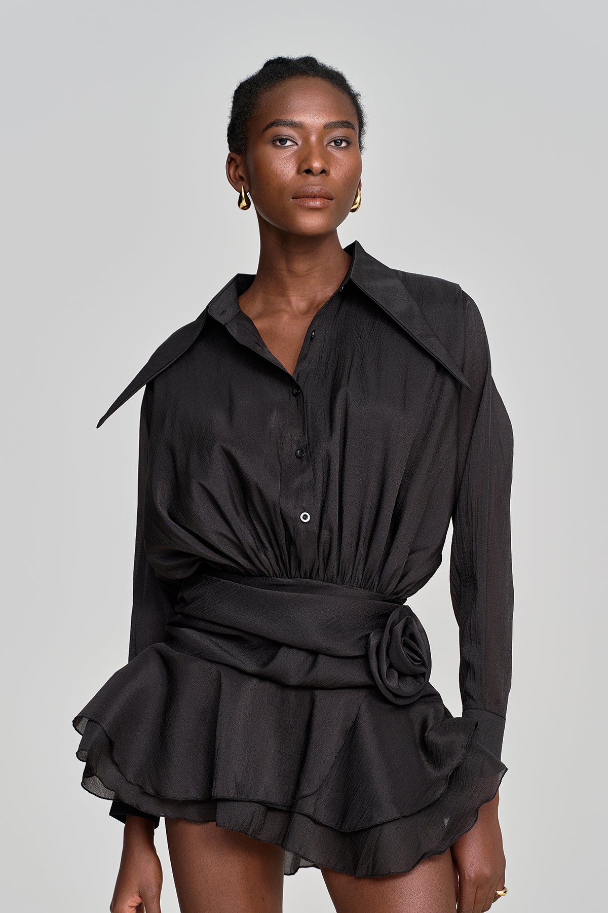 amina mini dress The Amina mini dress is crafted from exquisite lace, embellished with fringe details and shimmering sequins. Perfect for the lively wedding reception, its playful and dynamic accents come to life with every