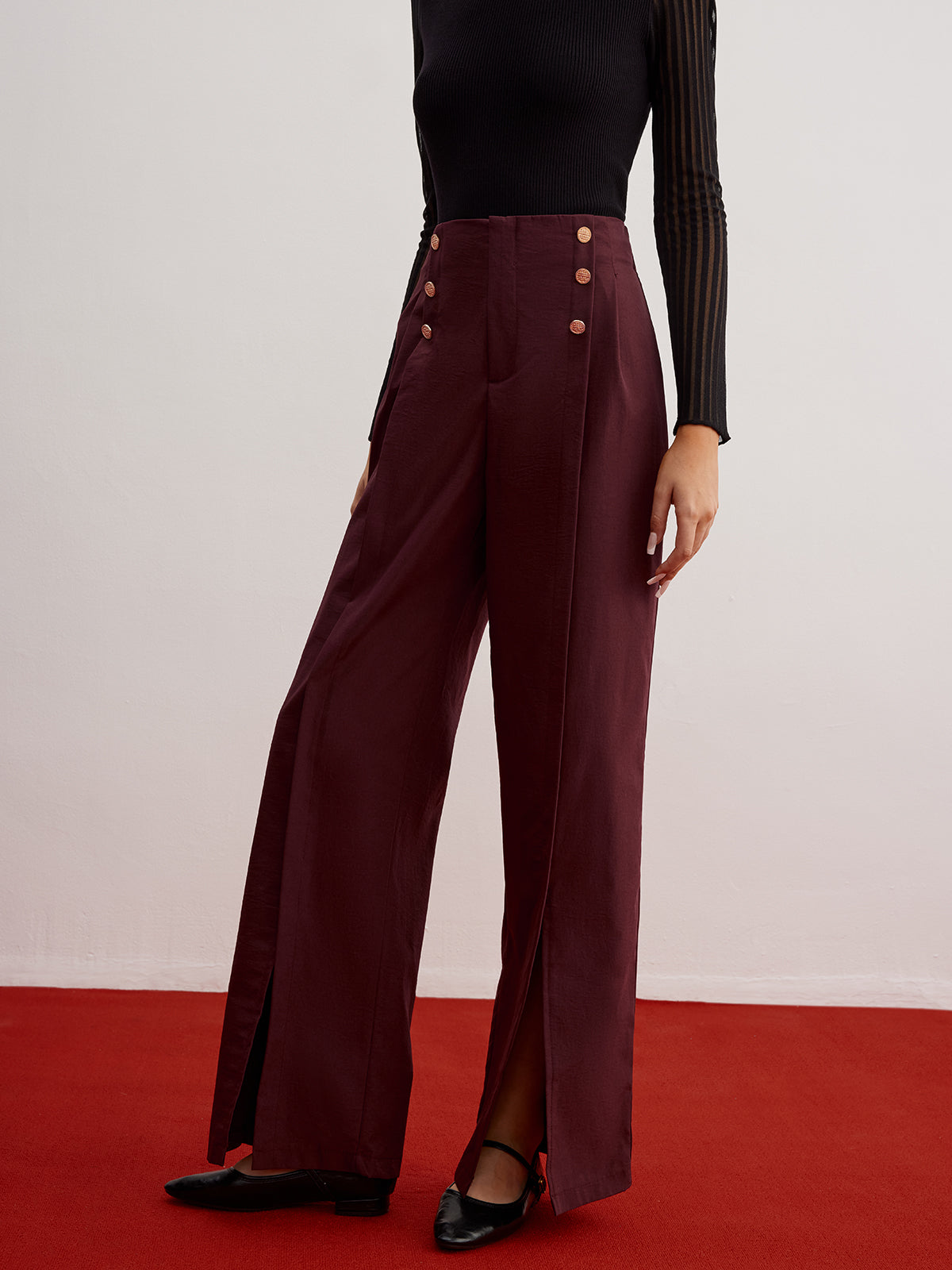 Wide-leg trousers with button detail and slit.