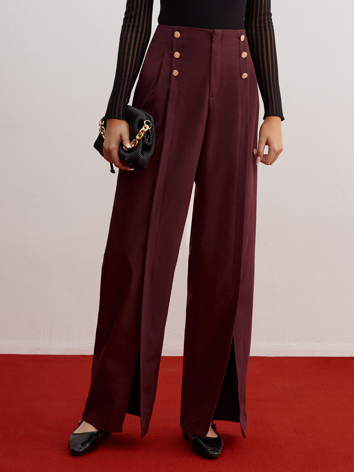 Wide-leg trousers with button detail and slit.