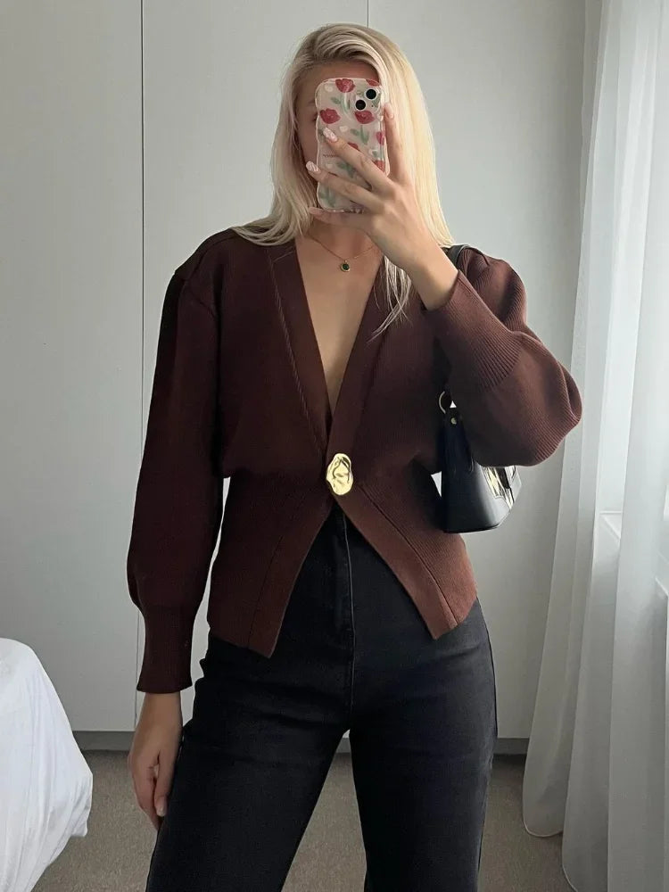 Goldene Strickjacke mit einem Knopf